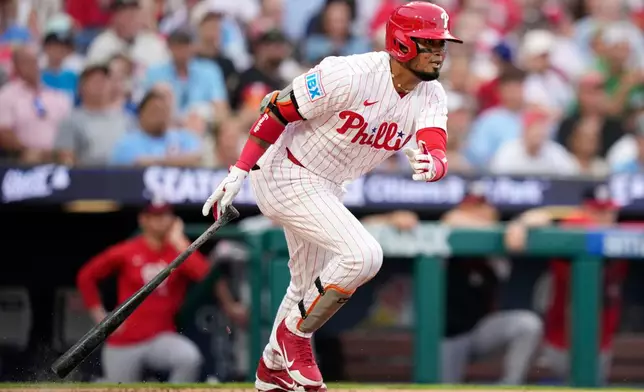 Philadelphia Phillies' Luis Arraez follows through after hitting a run-scoring double against Washington Nationals pitcher Zack Littell during the third inning of a baseball game Tuesday, Aug. 4, 2026, in Philadelphia. (AP Photo/Matt Slocum)