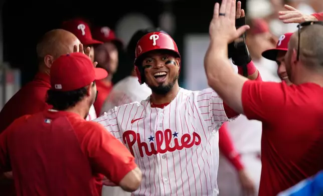 Philadelphia Phillies' Luis Arraez celebrates after scoring on a double by Brandon Marsh during the third inning of a baseball game against the Washington Nationals Tuesday, Aug. 4, 2026, in Philadelphia. (AP Photo/Matt Slocum)