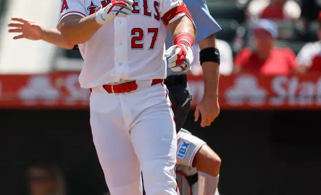 Los Angeles Angels designated hitter Mike Trout (27) reacts after being hit with a pitch during the first inning of a baseball game against the Philadelphia Phillies, Sunday, Aug. 30, 2026, in Anaheim, Calif. (AP Photo/Caroline Brehman)