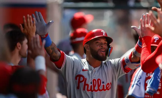 Philadelphia Phillies' Edmundo Sosa (33) is greeted by teammates after hitting a solo home run during the seventh inning of a baseball game against the Los Angeles Angels, Sunday, Aug. 30, 2026, in Anaheim, Calif. (AP Photo/Caroline Brehman)