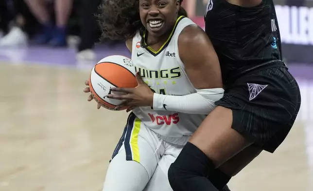 Dallas Wings guard Arike Ogunbowale, left, drives to the basket against Golden State Valkyries forward Kayla Thornton during the second half of a WNBA basketball game in San Francisco, Monday, Aug. 17, 2026. (AP Photo/Jeff Chiu)