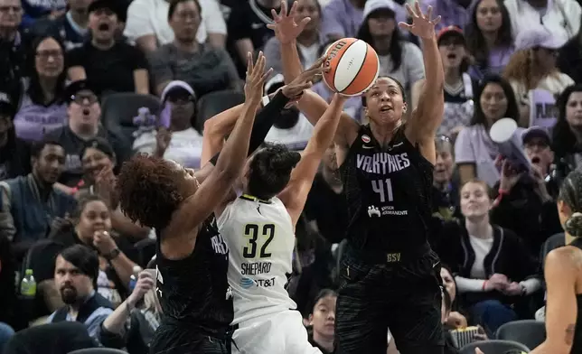 Golden State Valkyries forward Kayla Thornton, left, blocks a shot by Dallas Wings forward Jessica Shepard (32) and center Kiah Stokes (41) defends during the first half of a WNBA basketball game in San Francisco, Monday, Aug. 17, 2026. (AP Photo/Jeff Chiu)