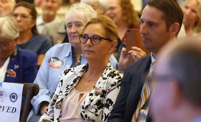 Sen. Darline Graham, R-S.C., center, waits for her turn to speak at a candidate event for hopefuls vying in a special Republican primary to replace her late brother Sen. Lindsey Graham, R-S.C., on November ballots, Saturday, Aug. 8, 2026, in Florence, S.C. (AP Photo/Meg Kinnard)