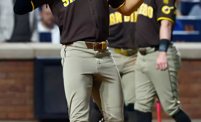 San Diego Padres' Fernando Tatis Jr. reacts after hitting thorn home run against the New York Mets during the fifth inning of a baseball game, Tuesday, Aug. 18, 2026, in New York. (AP Photo/Noah K. Murray)