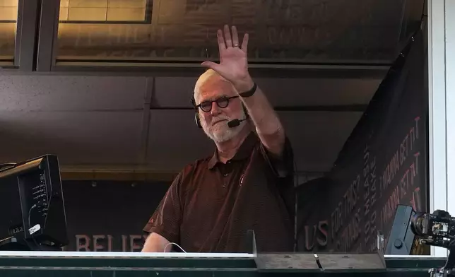 FILE - Radio broadcaster Mike Krukow waves before a baseball game between the San Francisco Giants and the San Diego Padres in San Francisco, Oct. 1, 2021. (AP Photo/Jeff Chiu, File)