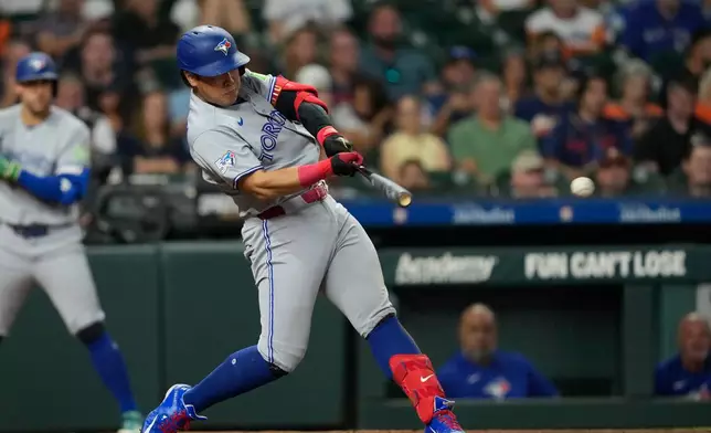 Toronto Blue Jays' Kazuma Okamoto hits a single against the Houston Astros during the fourth inning of a baseball game Monday, Aug. 3, 2026, in Houston. (AP Photo/David J. Phillip)