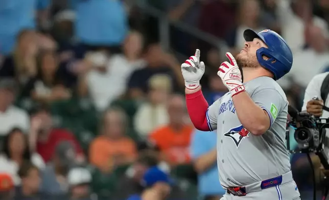 Toronto Blue Jays' Alejandro Kirk celebrates after hitting a home run against the Houston Astros during the second inning of a baseball game Monday, Aug. 3, 2026, in Houston. (AP Photo/David J. Phillip)