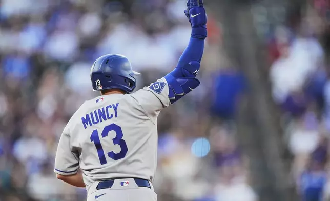 Los Angeles Dodgers' Max Muncy gestures to the bullpen as he circles the bases after hitting a three-run home run off Colorado Rockies starting pitcher Tomoyuki Sugano in the third inning of a baseball game Monday, Aug. 17, 2026, in Denver. (AP Photo/David Zalubowski)