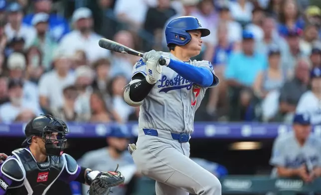 Los Angeles Dodgers' Shohei Ohtani singles off Colorado Rockies starting pitcher Tomoyuki Sugano in the third inning of a baseball game Monday, Aug. 17, 2026, in Denver. (AP Photo/David Zalubowski)