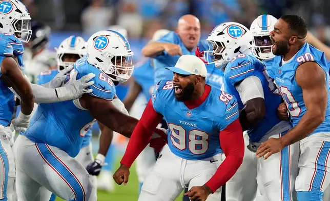 Tennessee Titans defensive lineman Jeffery Simmons (98) celebrates with teammates during the second half of a preseason NFL football game against the Seattle Seahawks, Sunday, Aug. 23, 2026, in Nashville, Tenn. (AP Photo/George Walker IV)