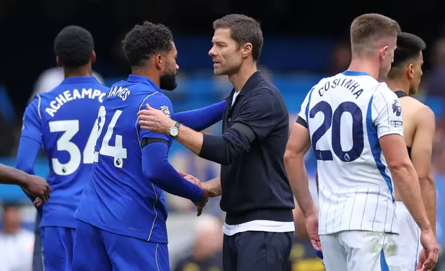 Chelsea's head coach Xabi Alonso greets Chelsea's Reece James after the English Premier League soccer match between Chelsea and Brighton and Hove Albion in London, Sunday, Aug. 30, 2026. (AP Photo/Ian Walton)