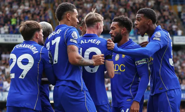 Chelsea's Cole Palmer, centre, celebrates with teammates after scoring his side's fourth goal during the English Premier League soccer match between Chelsea and Brighton and Hove Albion in London, Sunday, Aug. 30, 2026. (AP Photo/Ian Walton)