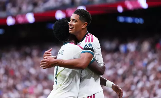 Real Madrid's Jude Bellingham celebrates with Real Madrid's Vinicius Junior Malaga's own goal during the La Liga soccer match between Real Madrid and Malaga in Madrid, Spain, Sunday, Aug. 30, 2026. (AP Photo/Manu Fernandez)