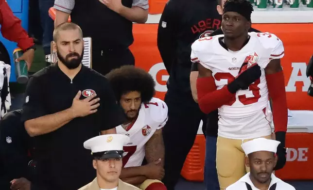 FILE - San Francisco 49ers quarterback Colin Kaepernick, middle, kneels during the national anthem before the team's NFL preseason football game against the San Diego Chargers, Thursday, Sept. 1, 2016, in San Diego. (AP Photo/Chris Carlson, File)