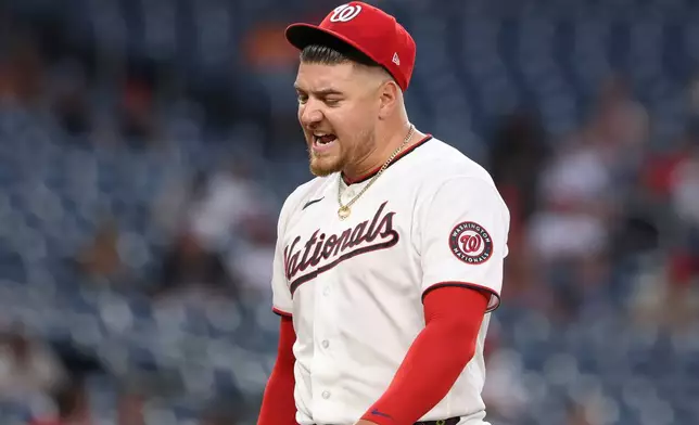 Washington Nationals pitcher Cade Cavalli reacts as he walks on the field during the third inning of a baseball game against the Colorado Rockies in Washington, Monday, Aug. 24, 2026. (AP Photo/Terrance Williams)
