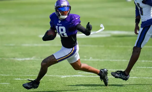 Minnesota Vikings wide receiver Justin Jefferson (18) makes a contested catch and out runs Baltimore Ravens cornerback Bilhal Kone (31) during a joint NFL football practice, Wednesday, Aug 19, 2026, in Eagan, Minn. (Alex Kormann/Minnesota Star Tribune via AP)