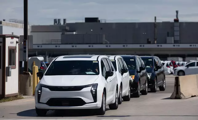 Chrysler Pacificas are driven off the lot at Windsor Assembly Plant in Windsor, Ontario, Canada, on Monday, Aug. 24, 2026. (Dax Melmer/The Canadian Press via AP)