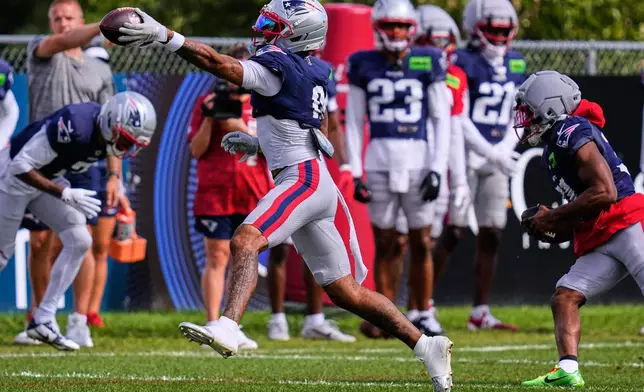 New England Patriots cornerback Christian Gonzalez catches a pass during an NFL football training camp, Tuesday, Aug. 25, 2026, in Foxborough, Mass. (AP Photo/Charles Krupa)