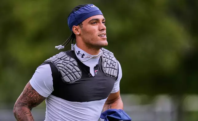 New England Patriots cornerback Christian Gonzalez runs towards a practice field during the team's NFL football training camp, Tuesday, Aug. 25, 2026, in Foxborough, Mass. (AP Photo/Charles Krupa)