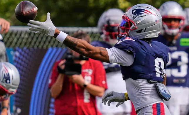 New England Patriots cornerback Christian Gonzalez catches a pass during an NFL football training camp, Tuesday, Aug. 25, 2026, in Foxborough, Mass. (AP Photo/Charles Krupa)