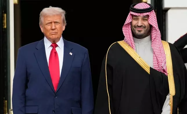 FILE - President Donald Trump stands with Saudi Arabia's Crown Prince Mohammed bin Salman on his visit to the White House, Nov. 18, 2025, in Washington. (AP Photo/Mark Schiefelbein, File)