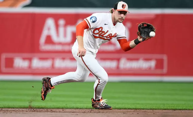 Baltimore Orioles shortstop Gunnar Henderson fields a ground ball by Philadelphia Phillies' Bryan de la Cruz during the third inning of a baseball game, Saturday, Aug. 1, 2026, in Baltimore. (AP Photo/Nick Wass)
