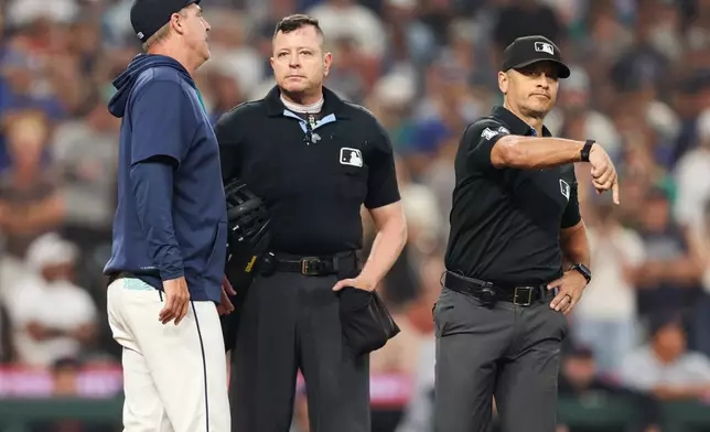 First base umpire Mark Wegner ejects Seattle Mariners manager Dan Wilson in the eighth inning of a baseball game against the Detroit Tigers, Wednesday, Aug. 5, 2026, in Seattle. (AP Photo/Kevin Ng)