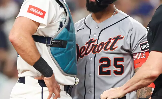 Detroit Tigers' Gleyber Torres (25) exchanges words with Seattle Mariners catcher Cal Raleigh (29) after being hit by a pitch in the eighth inning of a baseball game Wednesday, Aug. 5, 2026, in Seattle. (AP Photo/Kevin Ng)
