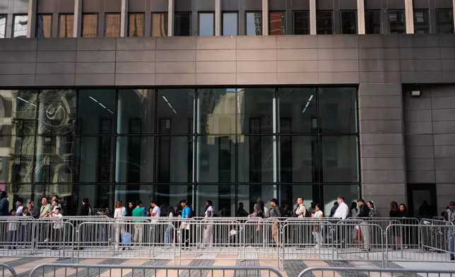 People wait in line to enter immigration courts and services in New York, Monday, July 27, 2026. (AP Photo/Seth Wenig)