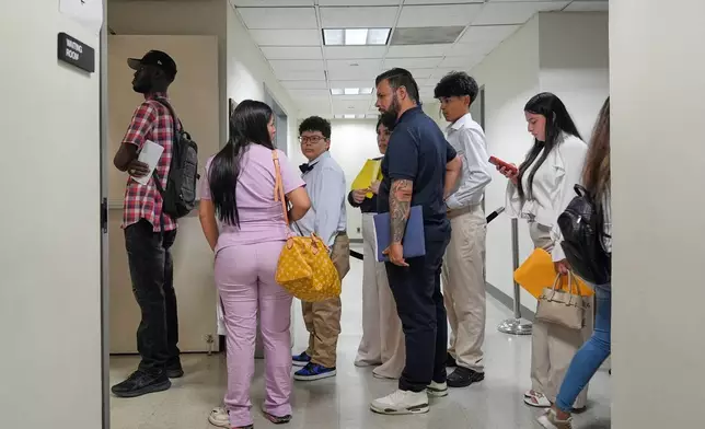 People stand in line for immigration court in New York, Monday, July 27, 2026. (AP Photo/Seth Wenig)