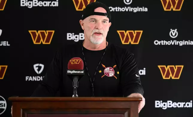 Washington Commanders head coach Dan Quinn speaks to the media before a joint practice with the Miami Dolphins at NFL football training camp, Wednesday, Aug. 12, 2026 in Ashburn, Va. (AP Photo/Nick Wass)
