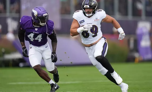 Baltimore Ravens tight end Mark Andrews (89) runs from Minnesota Vikings safety Joshua Metellus (44) during a joint NFL football practice, Thursday, Aug. 20, 2026, in Eagan, Minn. (AP Photo/Abbie Parr)