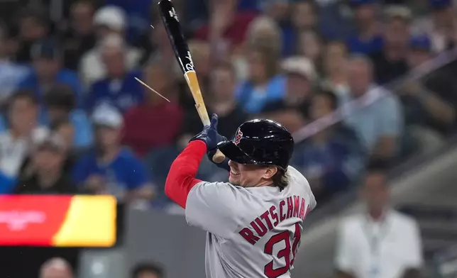 Boston Red Sox catcher Adley Rutschman (31) breaks his bat against the Toronto Blue Jays during first inning of a baseball game in Toronto on Wednesday, August 12, 2026. (Nathan Denette/The Canadian Press via AP)