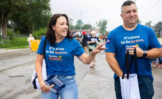 Denise Powell, left, the Democratic candidate for the House of Representatives in Nebraska's second congressional district, and her husband, Hobson, walk with the Nebraska Democratic Party in a Juneteenth Parade in Omaha, Neb., Saturday, Aug. 15, 2026. (AP Photo/Rebecca S. Gratz)