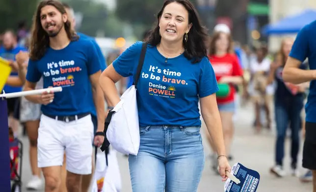 Denise Powell, the Democratic candidate for the House of Representatives in Nebraska's second congressional district, walks with the Nebraska Democratic Party in a Juneteenth Parade in Omaha, Neb., Saturday, Aug. 15, 2026. (AP Photo/Rebecca S. Gratz)
