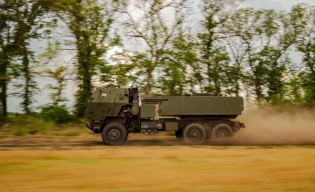 A Ukrainian HIMARS crew, attached to the 148th brigade, speeds to evade detection by reconnaissance drones along the front line in eastern Ukraine, on its way to fire rockets at Russian positions, Saturday, Aug. 8, 2026. (AP Photo/Dan Bashakov)