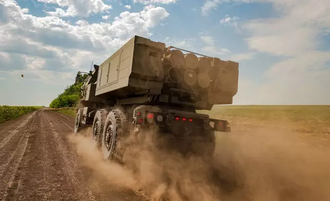 A Ukrainian HIMARS crew, attached to the 148th brigade, drives along the front line in eastern Ukraine, on its way to fire rockets at Russian positions, Saturday, Aug. 8, 2026. (AP Photo/Dan Bashakov)