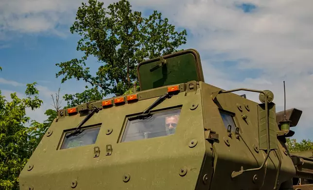 A member of a Ukrainian HIMARS crew, attached to the 148th brigade, drives the vehicle along the front line in eastern Ukraine, on its way to fire rockets at Russian positions, Saturday, Aug. 8, 2026. (AP Photo/Dan Bashakov)