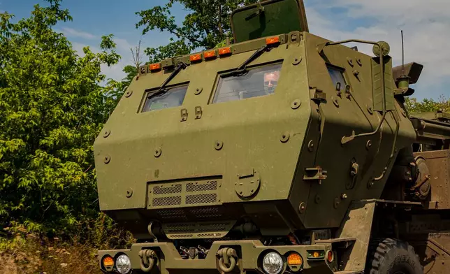 A member of a Ukrainian HIMARS crew, attached to the 148th brigade, drives the vehicle along the front line in eastern Ukraine, on its way to fire rockets at Russian positions, Saturday, Aug. 8, 2026. (AP Photo/Dan Bashakov)