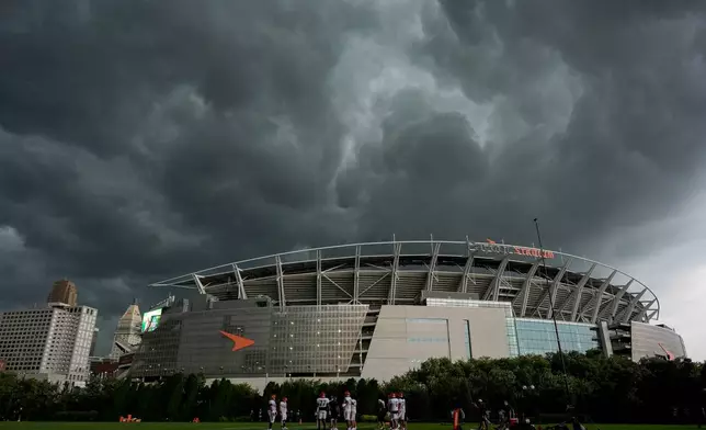 Storm clouds move in over Paycor Stadium and practice fields during the Cincinnati Bengals' NFL football practice in Cincinnati, Tuesday, Aug. 11, 2026. (AP Photo/Carolyn Kaster)