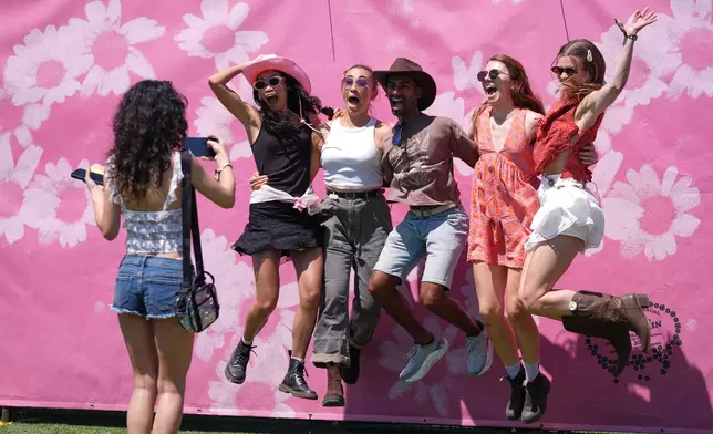 Festivalgoers leap in the air together for a group photo at the Daisy Chain Fields Music Festival at Great Park in Irvine, Calif., Saturday, Aug. 29, 2026. (AP Photo/Chris Pizzello)