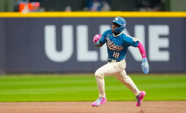 Milwaukee Brewers' Luis Lara runs to third base on a single hit by Jackson Chourio during the third inning of a baseball game against the Atlanta Braves, Friday, Aug. 21, 2026, in Milwaukee. (AP Photo/Kayla Wolf)