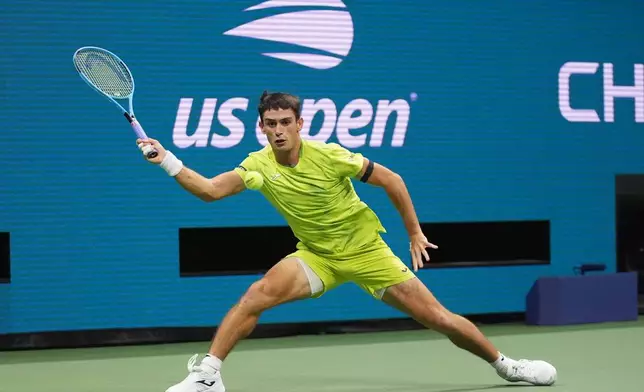 Mariano Navone, of Argentina, returns the ball to Novak Djokovic, of Serbia, during the first round of the U.S. Open tennis championships Sunday, Aug. 30, 2026, in New York. (AP Photo/Frank Franklin II)