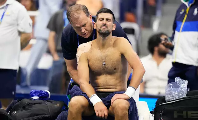 Novak Djokovic, of Serbia, gets medical treatment during the first round of the U.S. Open tennis championships against Mariano Navone, of Argentina, Sunday, Aug. 30, 2026, in New York. (AP Photo/Frank Franklin II)