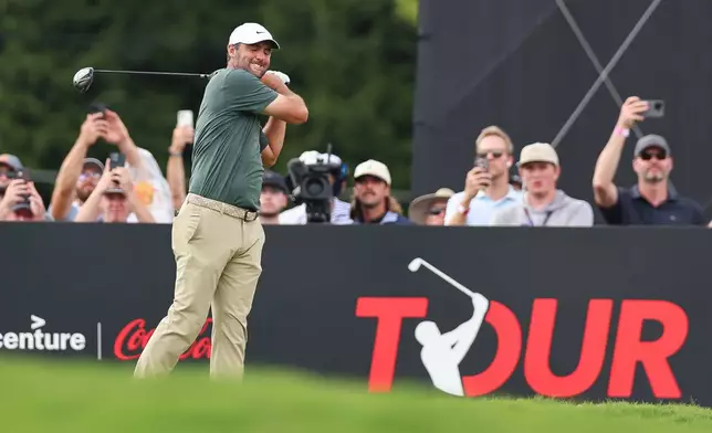Scottie Scheffler reacts after playing his tee shot on the 18th hole during the second round of the Tour Championship golf tournament, Friday, Aug. 28, 2026, in Atlanta. (AP Photo/Colin Hubbard)