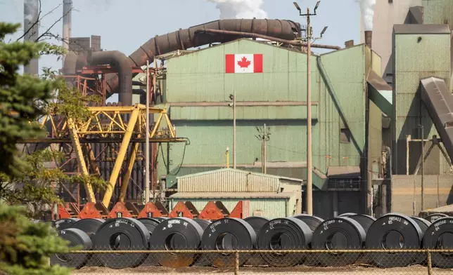 Rolled coils of steel sit in the yard at the ArcelorMittal Dofasco steel plant in Hamilton, Ont. on Thursday, Aug. 20, 2026. (Nick Iwanyshyn /The Canadian Press via AP)