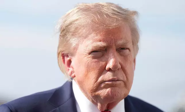 President Donald Trump speaks with reporters before boarding Air Force One, Friday, Aug. 21, 2026, at Joint Base Andrews, Md., en route to South Carolina. (AP Photo/Jacquelyn Martin)