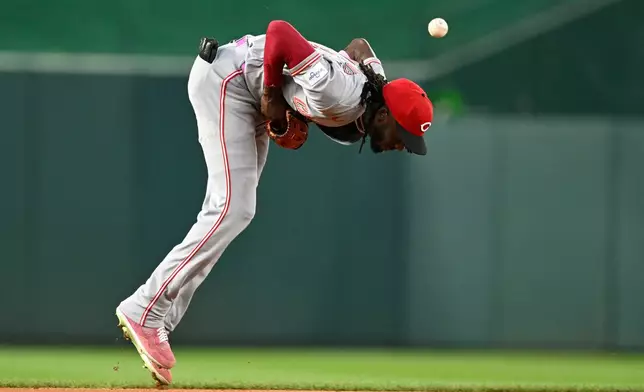 Cincinnati Reds shortstop Elly de la Cruz commits a fielding error on a ground ball hit by Washington Nationals' Brady House during the first inning of a baseball game, Friday, Aug. 7, 2026, in Washington. (AP Photo/John McDonnell)