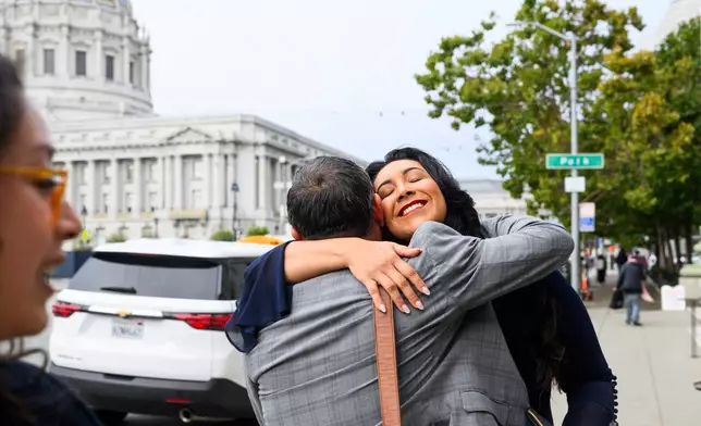 Plaintiff Clarissa Cervantes hugs a legal team member before attending a hearing about Riverside County Sheriff Chad Bianco's seizure and recount of more than half a million 2025 election ballots on Monday, Aug. 24, 2026, in San Francisco. (AP Photo/Noah Berger)