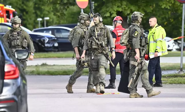 Police and emergency personnel outside Brinellskolan during a major emergency response after a man with a sword reportedly injured several people at the school in Fagersta, Sweden, Friday, Aug. 21, 2026. (Fredrik Sandberg/TT News Agency via AP)